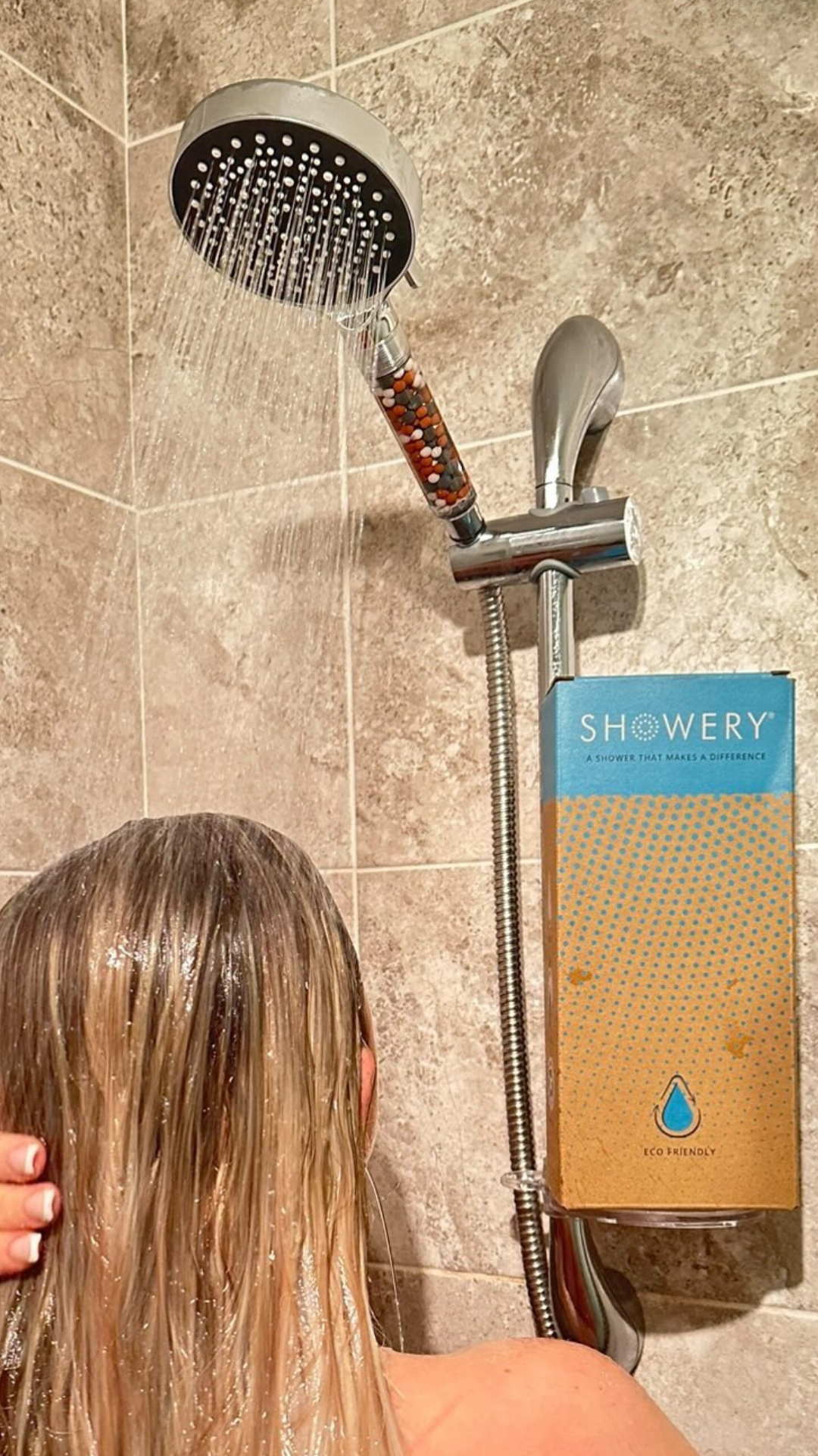 woman showering with a water softening shower head